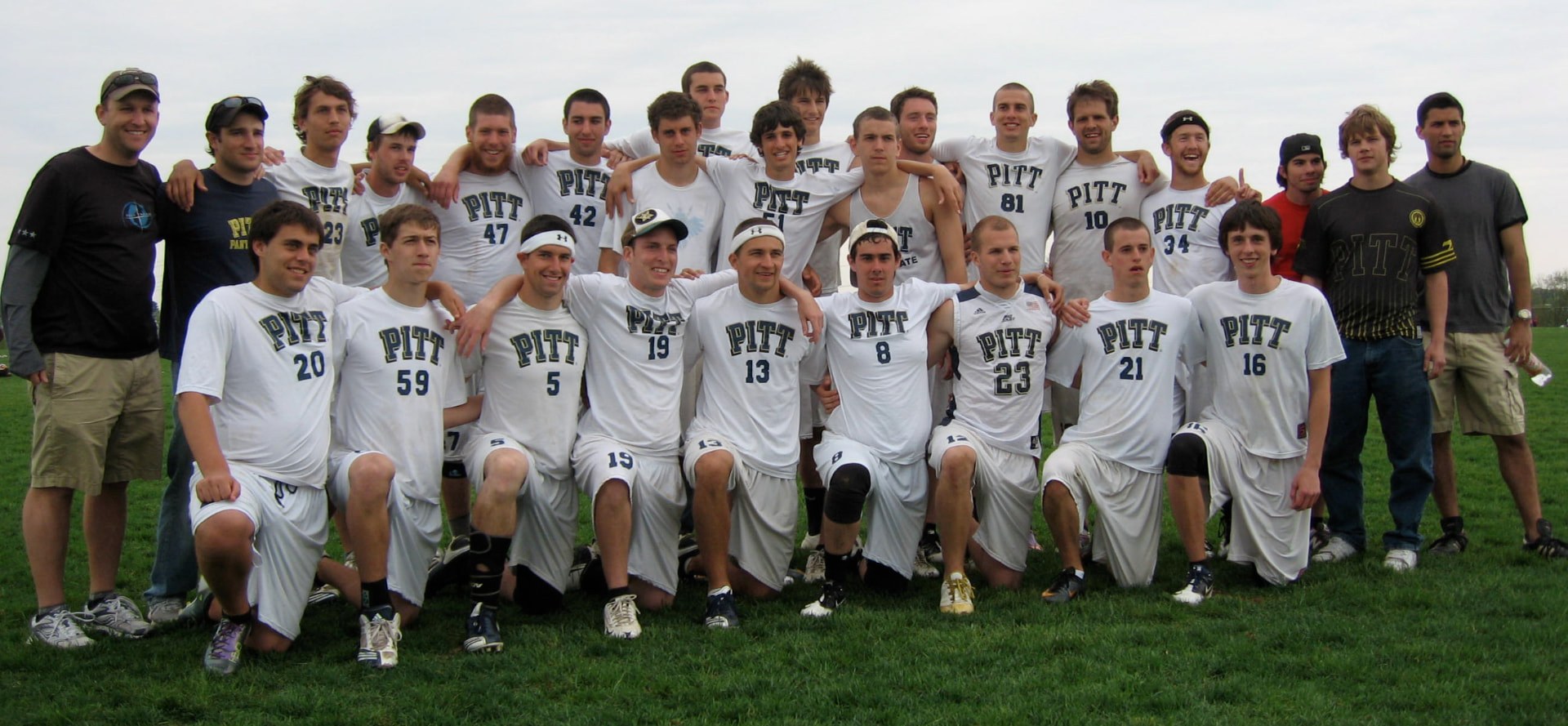 Full Pitt roster in white jerseys on the field, 2011