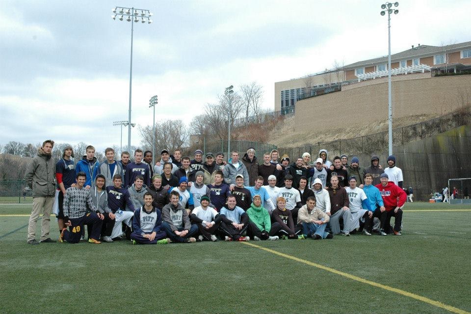 Alumni and current players lined up on a cold day for the alumni game, 2014